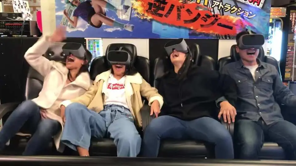 Friends at RED° TOKYO TOWER experience VR Reverse Bungee, wearing VR headsets and laughing excitedly on a dynamic platform, feeling the unique virtual reality thrill and exhilaration beneath Tokyo Tower.