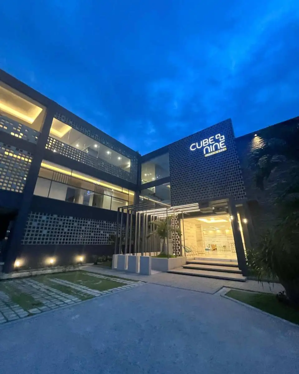 The modern exterior of Cube Nine Resort & Spa in Mactan, Cebu, illuminated at night, showcasing its contemporary architecture and welcoming ambiance for luxury spa stays.
