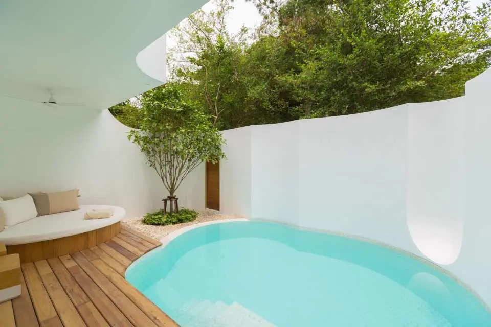 Indulge in a luxurious private outdoor pool, set within a spacious sunbathing deck and lush, secluded gardens