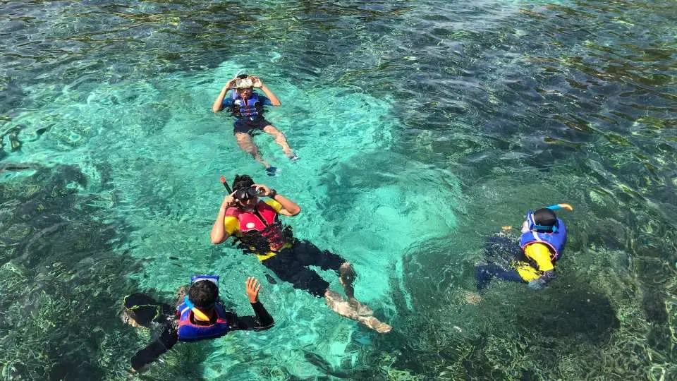 Island Hopping Day Tour in Nha Trang: Coral Reef, Fishing Village, and Tranh Beach - Slip on your snorkeling gear, then take a plunge underneath dazzling blue waters to get a peek at the vibrant underwater world. Be amazed at the burst of color hidden beneath the surface, from the lush coral reefs to diverse marine life.  Find out how locals cultivate seafood at the Fishing Village and learn how a fish farm raft works as it floats out at sea. Then, make your way to Tranh Beach, a pristine beach with a variety of fun water sports, such as parasailing.