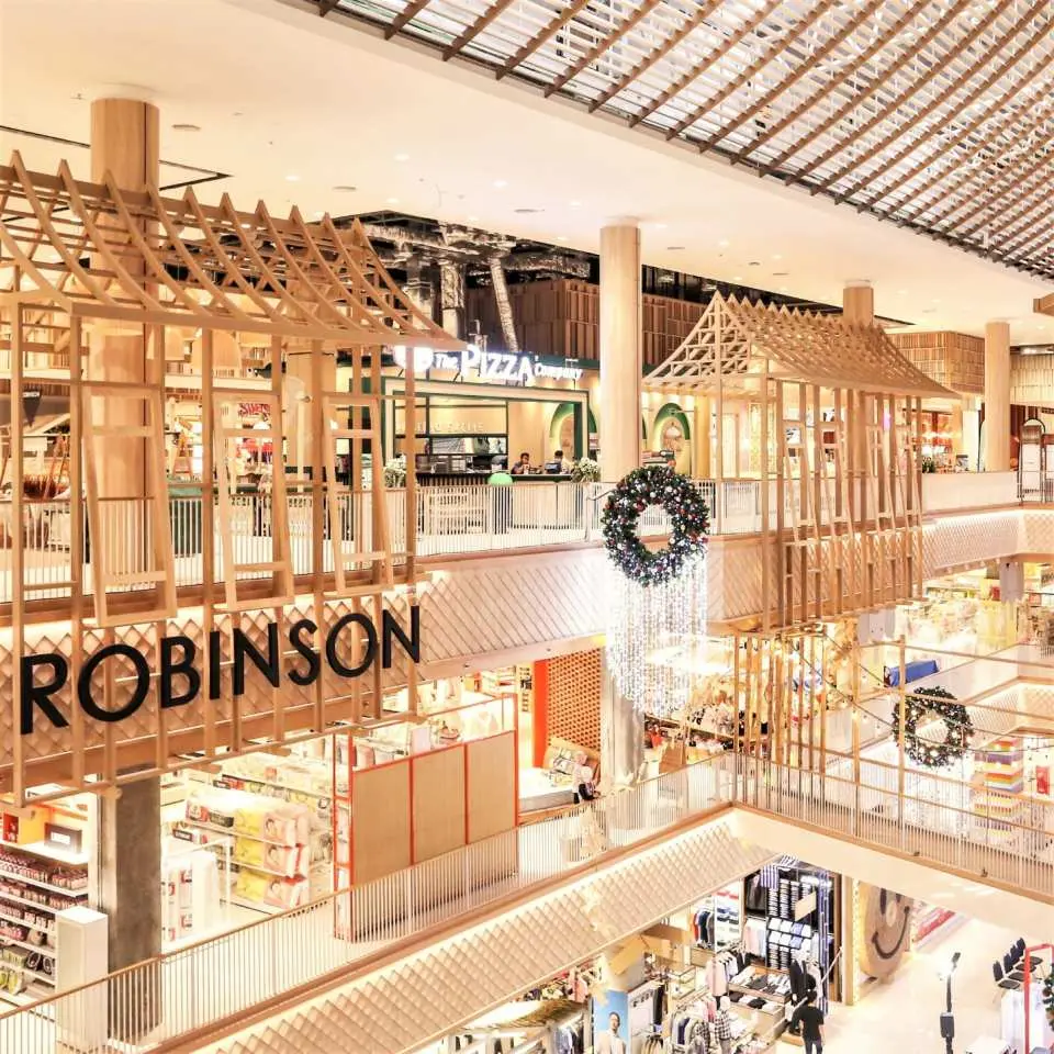 Inside Robinson department store in Ayutthaya, a modern shopping space featuring unique Thai-style wooden house designs, offering a blend of shopping and leisure experiences.