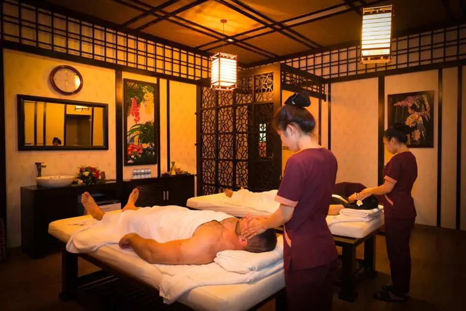 Inside a luxurious spa room at Galina Hotel & Spa in Nha Trang, two experienced therapists provide professional, soothing massages for guests.