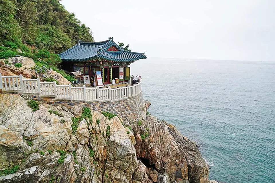 Visit Naksansa Temple, a stunning seaside temple in Gangwon-do where dramatic cliffs meet the beautiful blue waters of the East Sea.