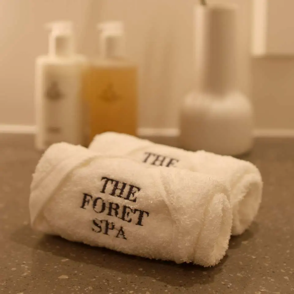 Branded towels and a range of high-quality spa products at THE FORET SPA Seongsu in Seoul, showcasing attention to detail and enhancing the exclusive customer experience.