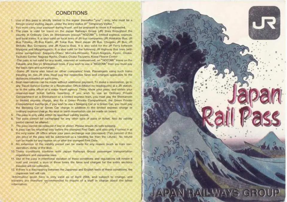 摊开的日本铁路周游券兑换券页面，左侧详细列出使用条款，右侧为JR PASS卡面设计，提醒旅客购买前须知。