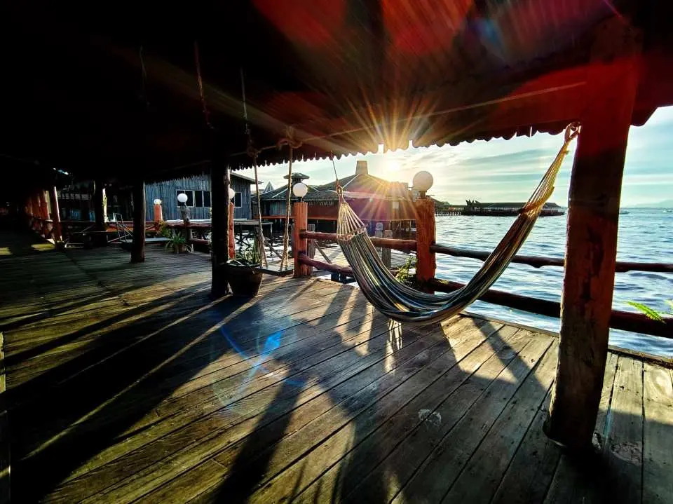 Le'one Spa overwater platform in Semporna, with a comfortable hammock bathed in sunset glow, inviting guests to relax and enjoy captivating sea views.