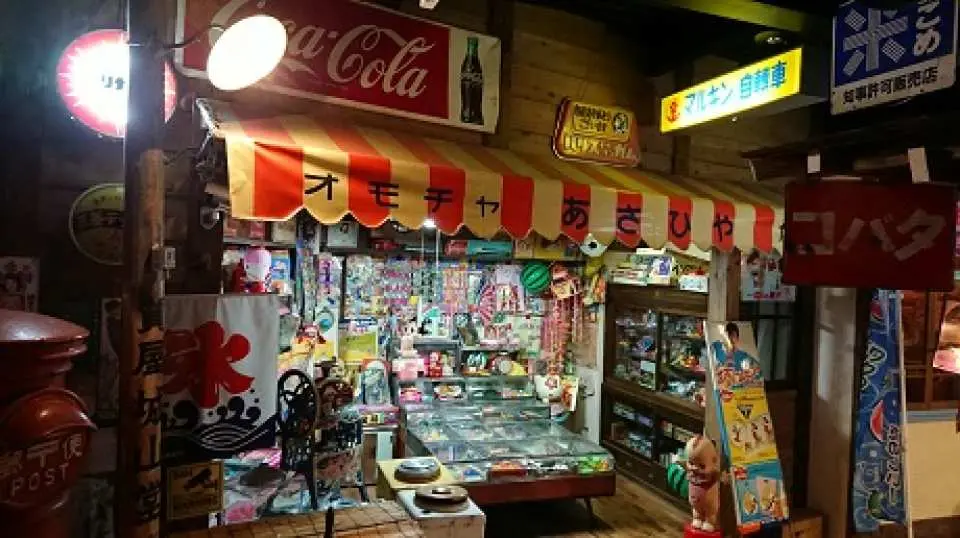 There are many different shops lined up with hand-painted signs.