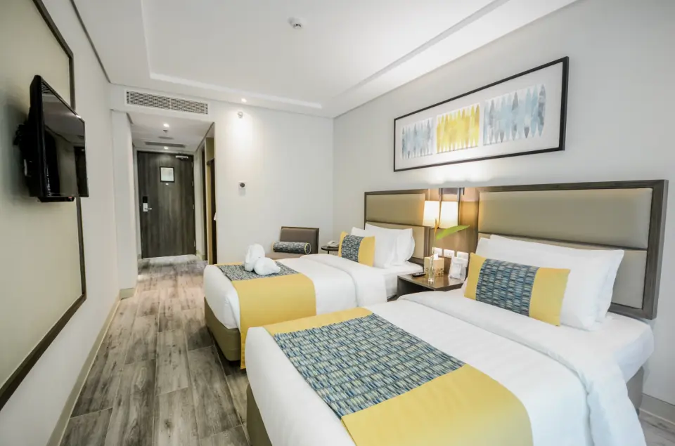 Deluxe Rooms: 27 sqm, featuring either queen or twin beds, perfect for a cozy stay.