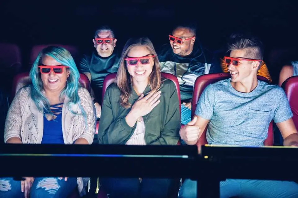 Audience members wearing 3D glasses, enjoying an exciting immersive viewing experience in the Marvel Universe 4D/7D cinema at Madame Tussauds New York.