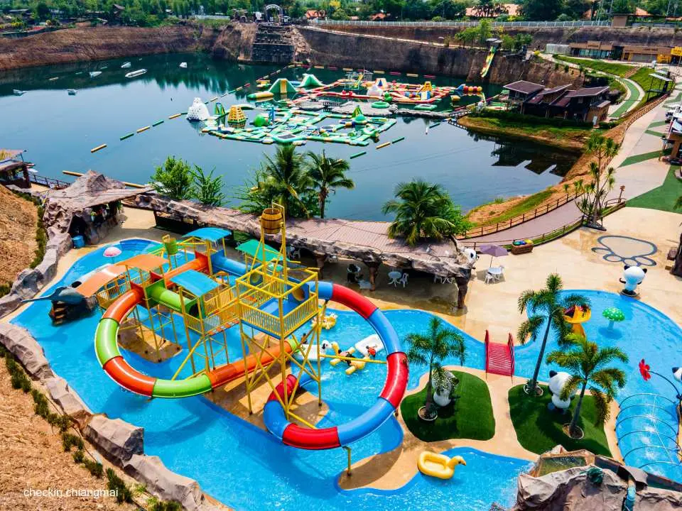 Aerial view of the children's play area at Chiang Mai Grand Canyon Water Park, featuring colorful winding slides and diverse water facilities, perfect for family fun.