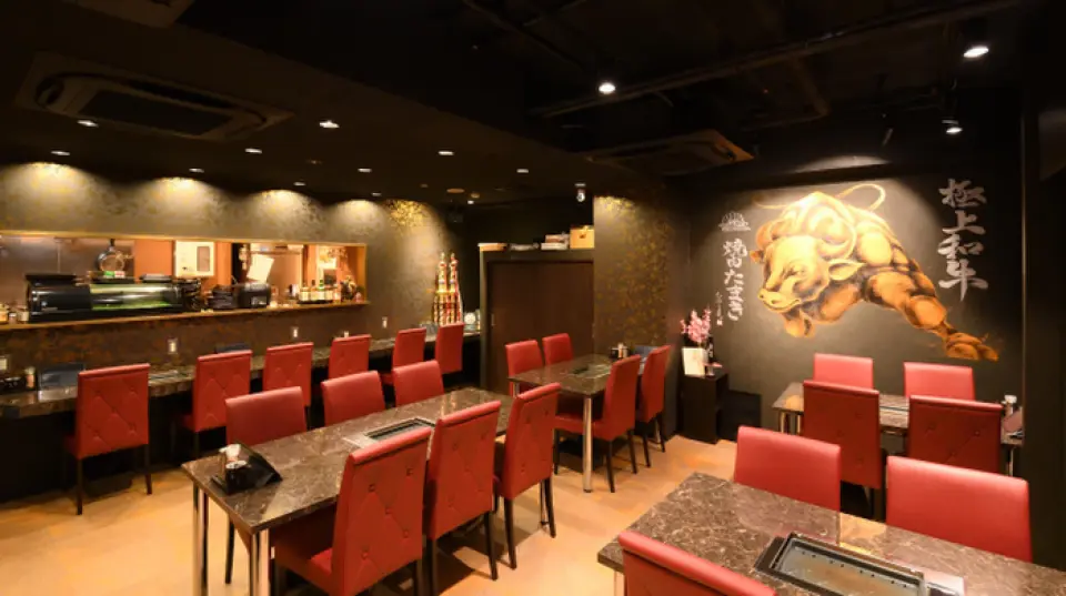 The interior of the restaurant is decorated with pictures of cows and offers sunken kotatsu tables, tables and a counter.