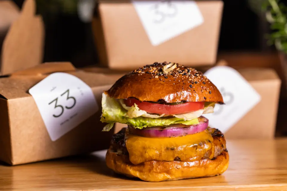The 100% beef patty is packed with delicious, melt-in-your-mouth flavor and topped with melted cheddar cheese. It's sandwiched in a homemade brioche bun. The deep flavor of Chef Ian's original "Tomato Chutney" that accompanies the sandwich goes perfectly with the burger.