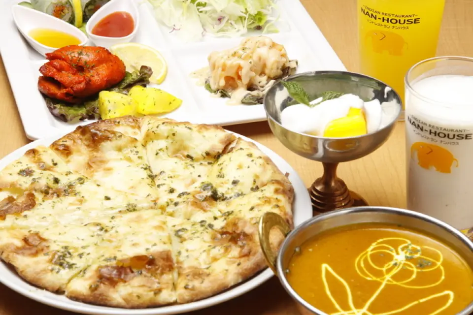 Curry isn't the only thing Nan House is proud of. We have a wide variety of naan available for you to enjoy. Baked in a flash in our custom-made tandoori, our naan is crispy on the outside and chewy on the inside. We have a variety of naan, including cheese naan made with specially selected cheese, premium cheese naan made with higher-grade cheese such as Gouda or cheddar, one of the world's four major cheeses, honey naan that kids love, and chocolate naan!