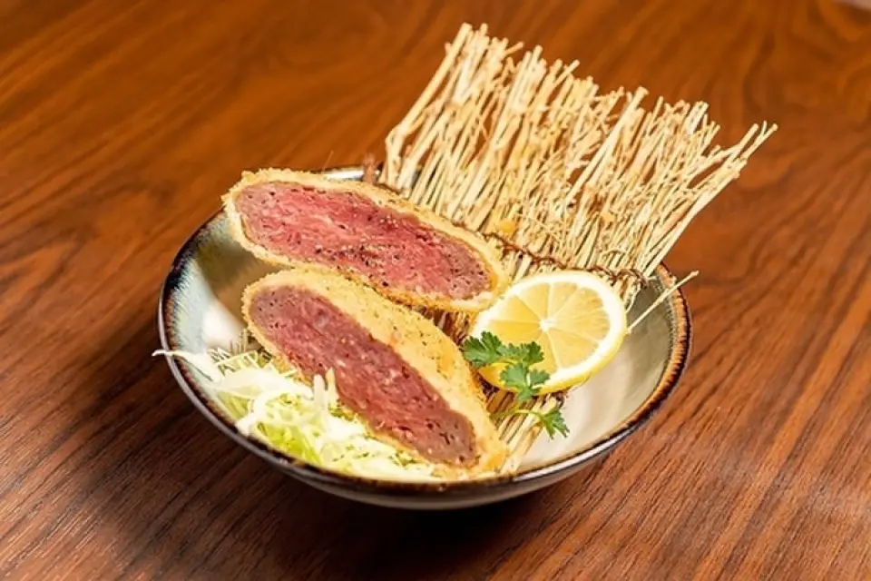 Our handmade medium rare minced meat cutlet is made with Japanese beef and comes with our original spices and homemade sauce.