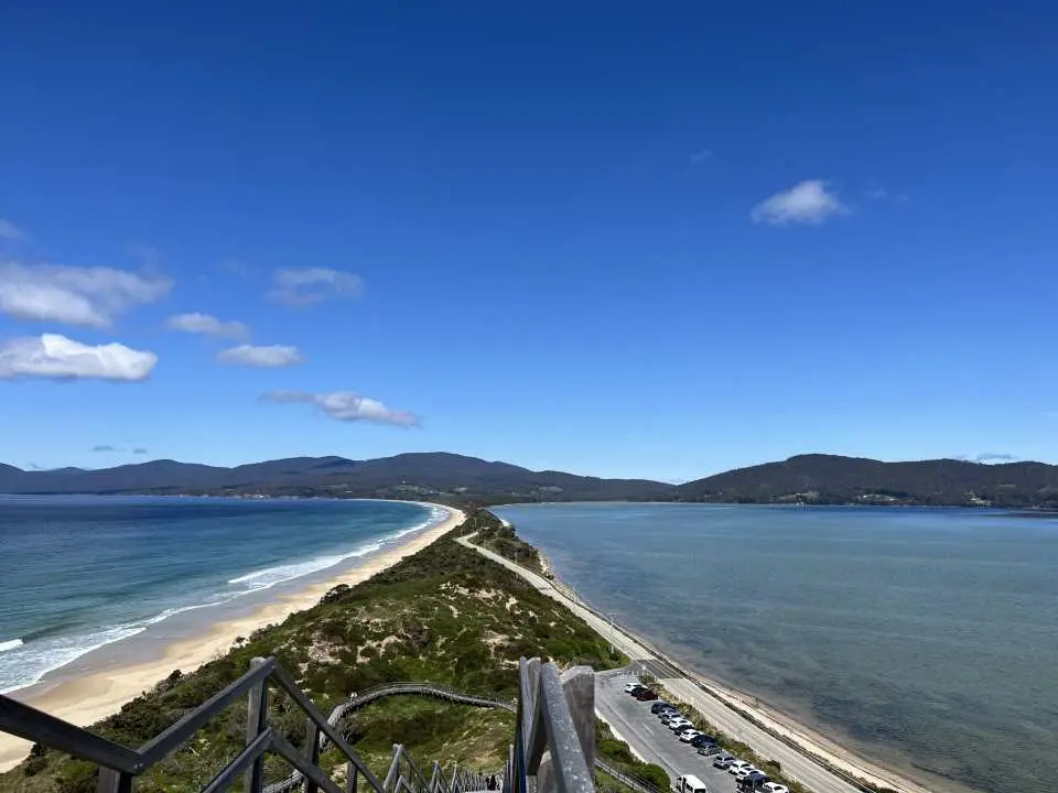 The iconic 'Neck' on Bruny Island, Tasmania, a stunning narrow strip of land separating two distinct bodies of water, viewed from a high lookout point.