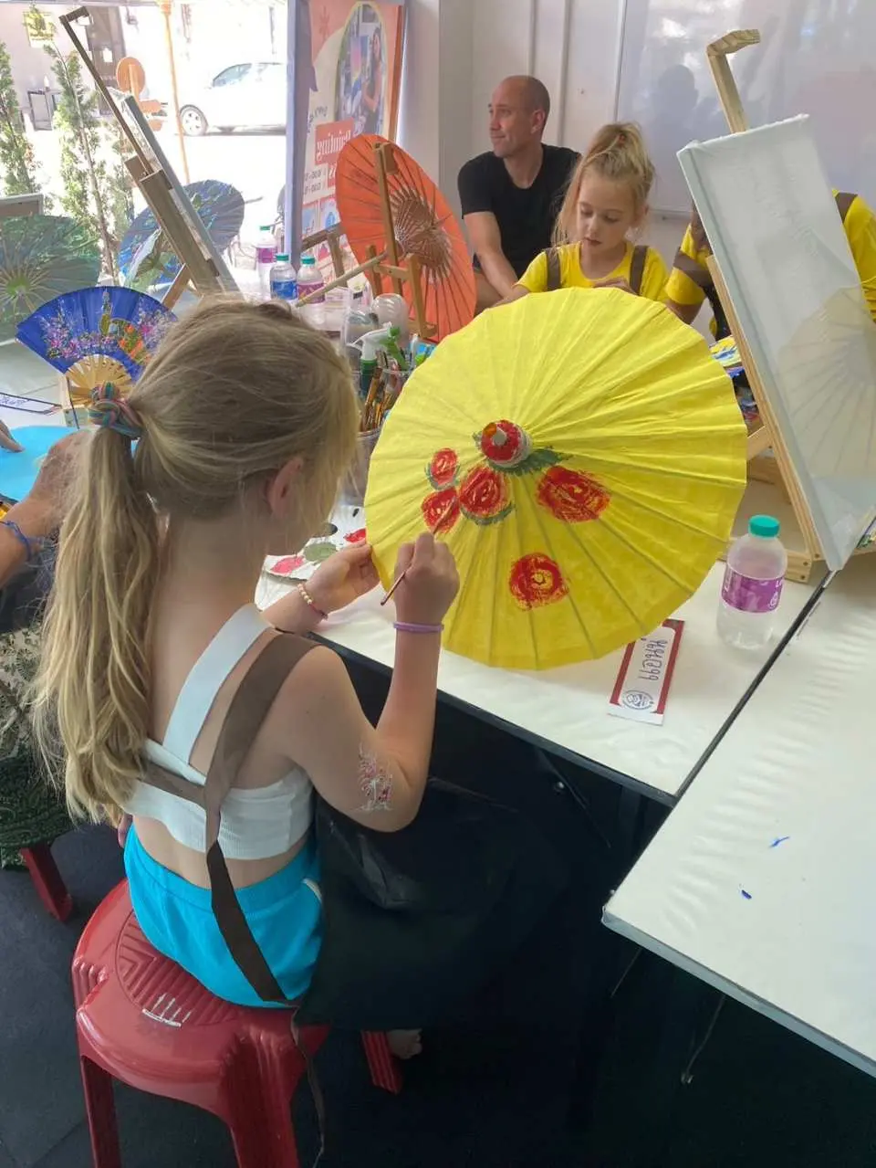 Create a painting on a handmade Chiang Mai paper umbrella, crafted from mulberry paper which is a traditional and unique feature of Chiang Mai.