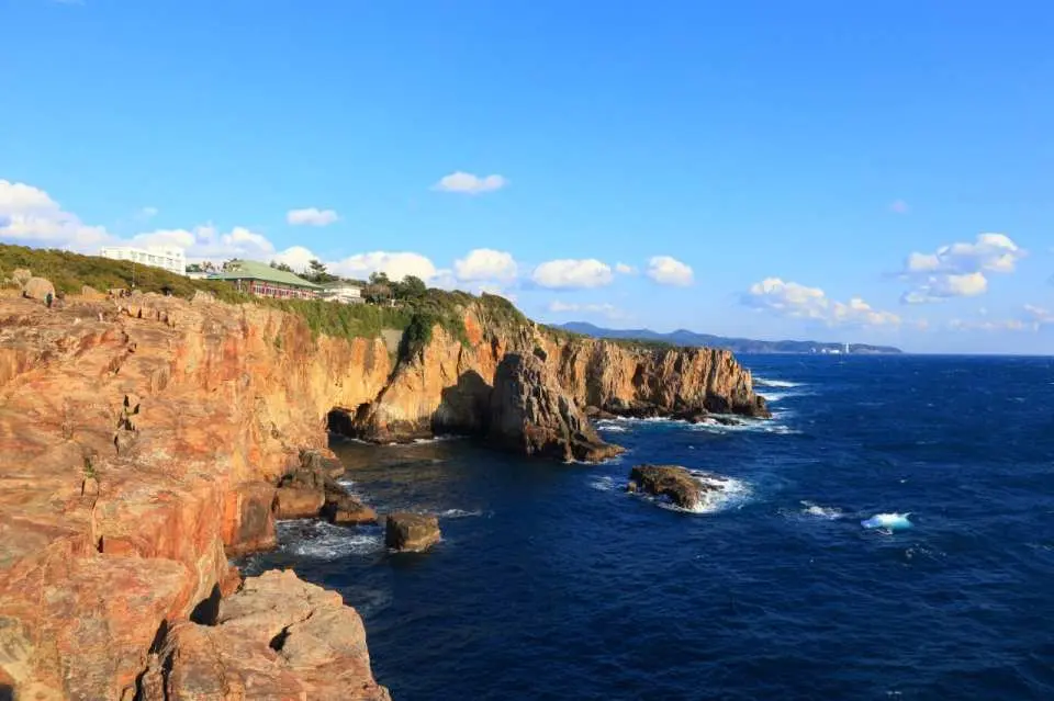 The magnificent Sandanbeki sea cliffs in Wakayama Shirahama, where rugged cliffs meet the deep blue Pacific Ocean, showcasing the grandeur of the Nanki coast.