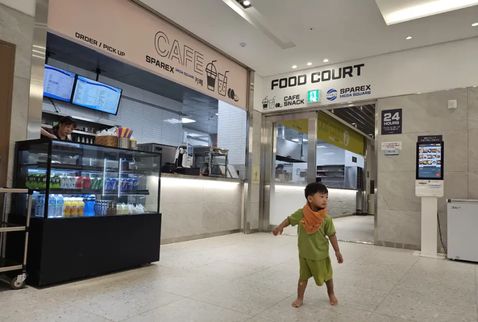 Entrance to the cafe and food court inside Seoul's SPAREX jjimjilbang, offering diverse dining options for travelers to enjoy after relaxing.