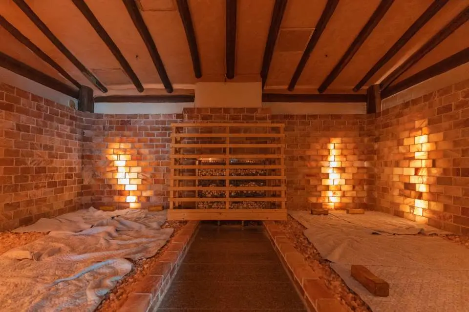 Interior of Busan Haeundae HILL SPA's warm and comfortable Korean jjimjilbang, with brick walls and wooden ceiling creating a traditional ambiance, offering an excellent relaxing experience with soft lighting.