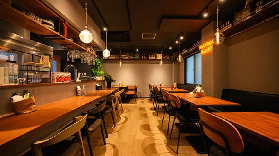 Please relax and unwind in our chic, calming hideaway-like restaurant. The restaurant is bright with indirect lighting during the day, and has a moody atmosphere at night. The stylish interior, with its concrete, potted plants, and neon lights as its main features, has a charming, homey atmosphere. Seating is available at the open kitchen counter and comfortable sofa tables. The counter chairs are low, making it easy to sit in, and can be enjoyed by people of all ages. Please feel free to drop by.