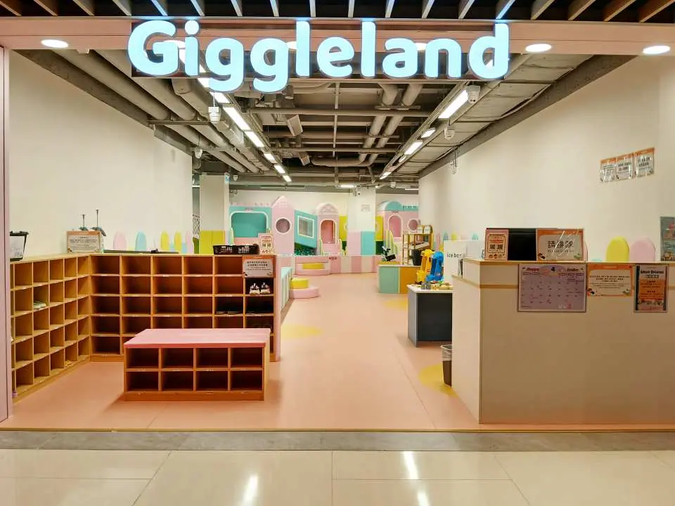 西環Giggleland馬卡龍樂園的歡迎入口，清晰可見標誌和內部寬敞明亮的遊樂環境，邀請親子一同體驗夢幻樂園。