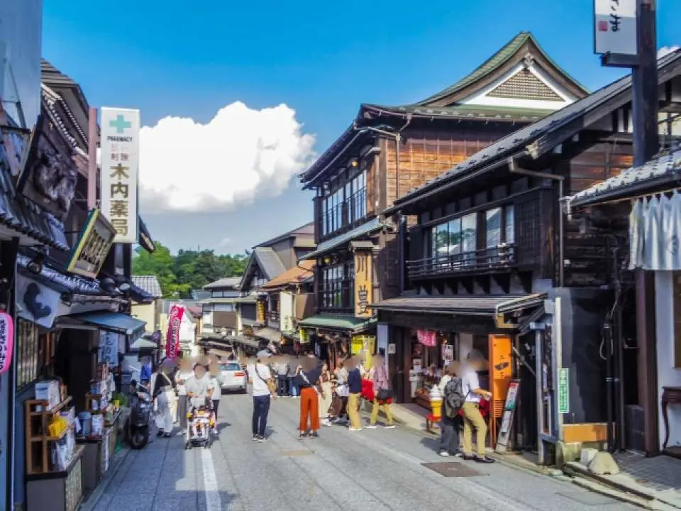 東京近郊成田山新勝寺表參道老街風情，兩旁傳統木造建築林立，遊客悠閒散步體驗當地文化。