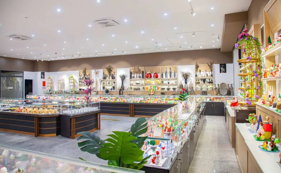 The spacious and brightly lit souvenir shop at Nha Trang's 100 Eggs Mud Bath Spa Theme Park, featuring a wide array of gifts and local specialty products for visitors.