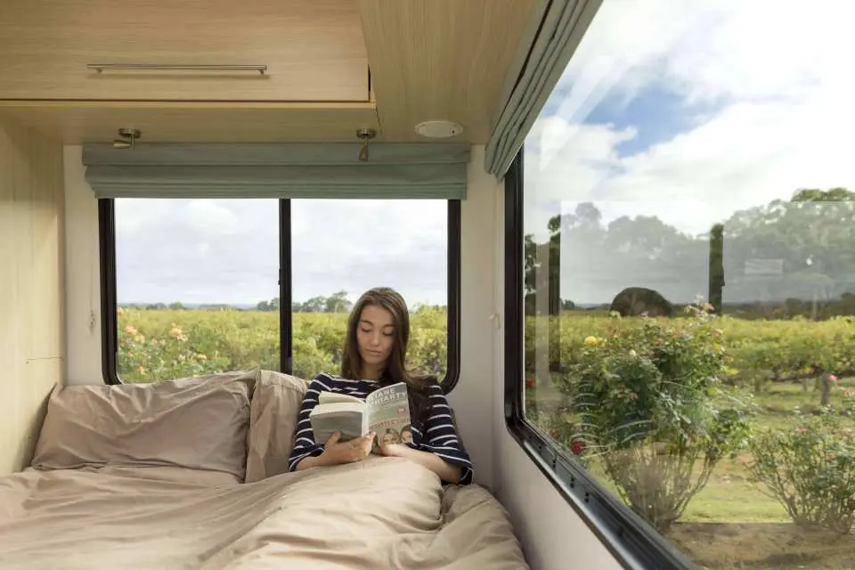 Woman reading inside campervan
