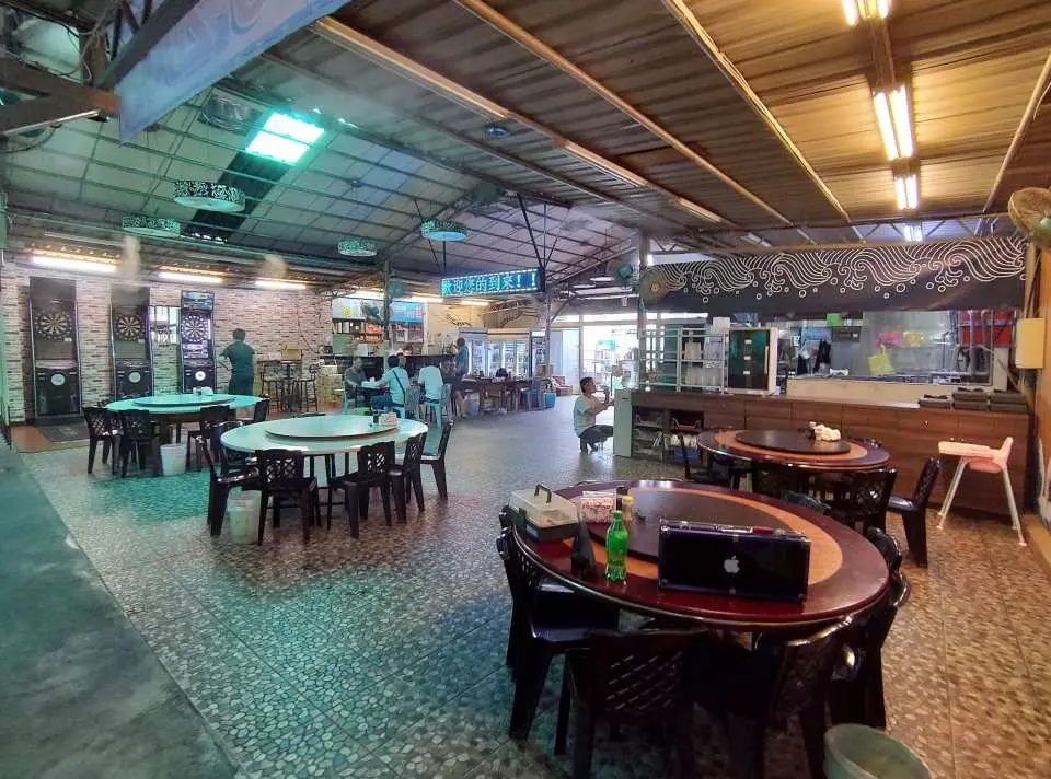 พื้นที่รับประทานอาหารกว้างขวางภายในสถานที่ตกกุ้งในร่มที่ไทเป มีโต๊ะและเก้าอี้มากมาย เหมาะสำหรับเพลิดเพลินกับอาหารทะเลที่ปรุงสดใหม่และอาหารท้องถิ่น