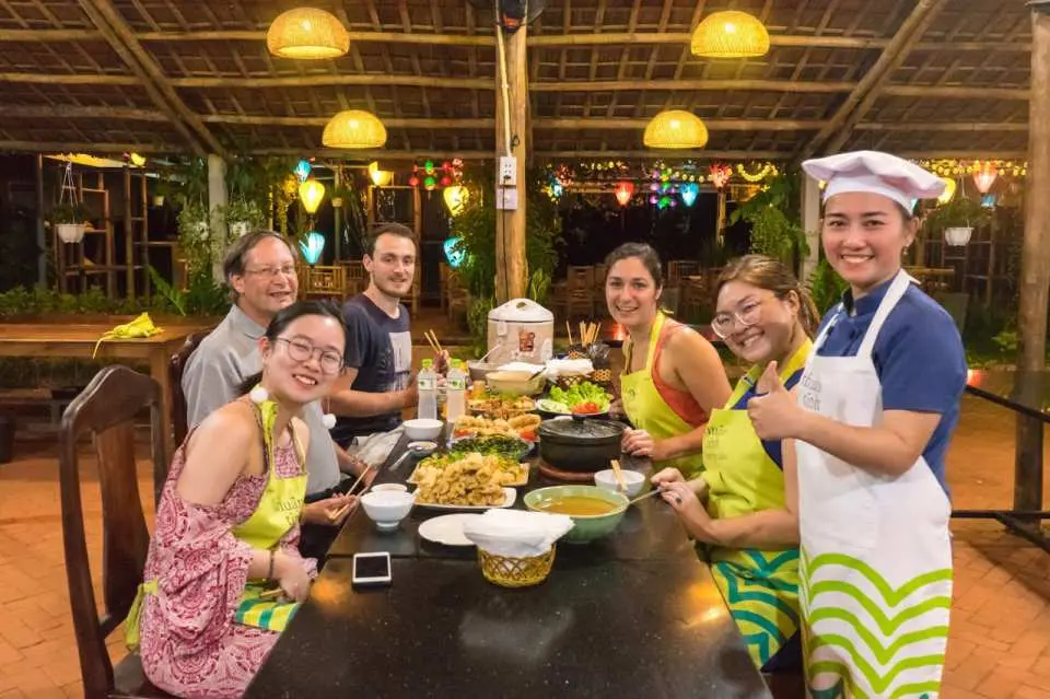 Enjoy the family-style dinner underneath the lanterns during sunset, deep inside the water-coconut forest