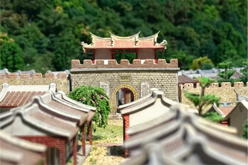 A detailed miniature model of Zuoying Old City gate displayed at Jiancheng Museum, recreating the magnificent grandeur and intricate details of this historical monument for visitors.