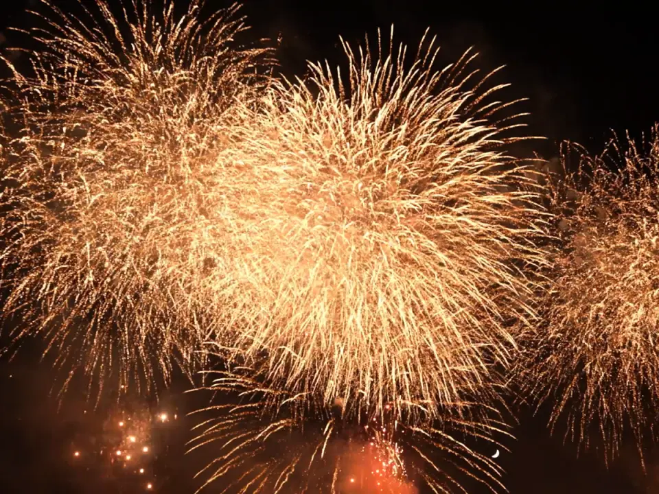 A spectacular display of thousands of golden fireworks simultaneously exploding in the night sky over the Akigawa River basin during the Akiruno City Fireworks Festival in Tokyo.
