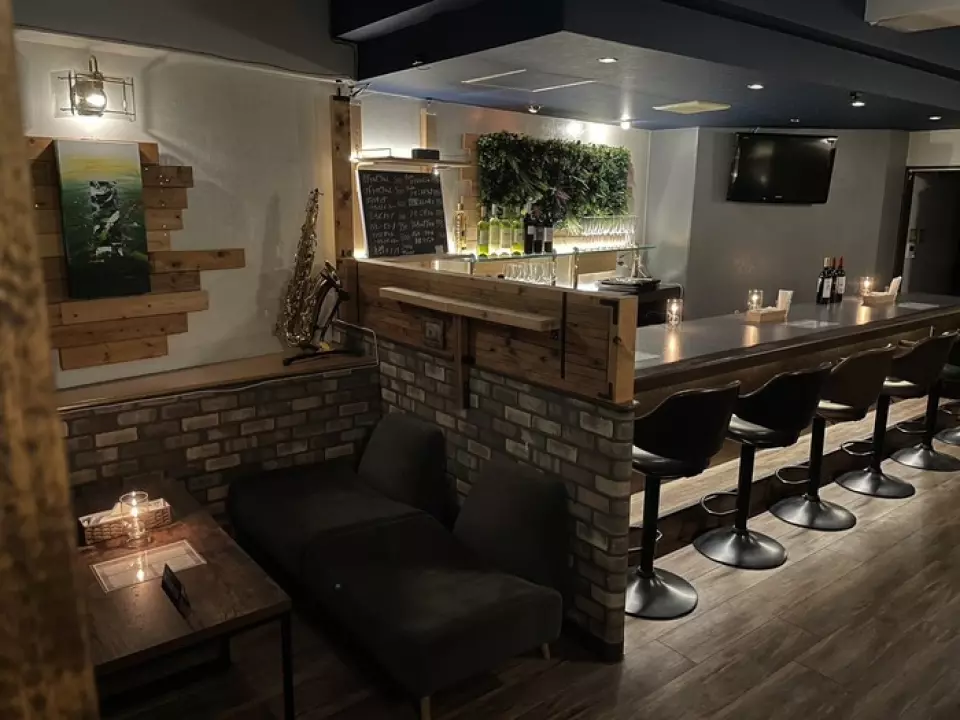 The interior, decorated with wall greenery and brick-style wallpaper, has a lounge-like, calming atmosphere that could be described as an adult hideaway. The oil candles on the tables and the wine bottles displayed throughout the restaurant also add to the mature atmosphere. In addition to counter seating, there are box seats and sofa seats that can accommodate 4 to 6 people, making it suitable for a variety of occasions, such as dining with friends, girls' nights, and business entertainment.