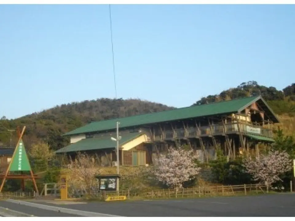 The landmark is a warm wooden building nestled in a peaceful rural landscape.