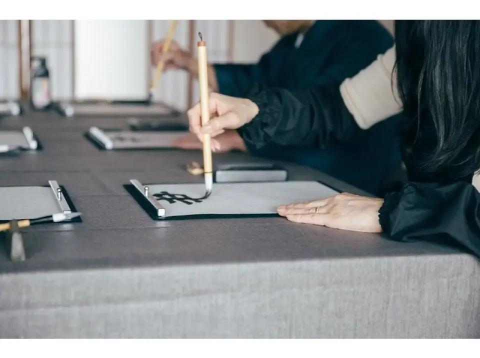 During the calligraphy experience, you grind the ink and concentrate your mind.