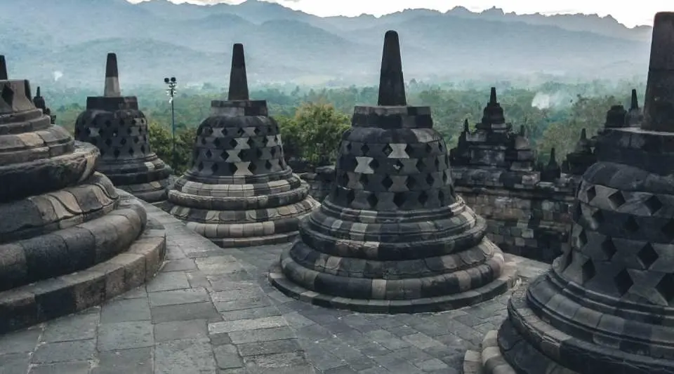 Ascend through the temple’s levels and admire detailed stone carvings that reflect ancient Buddhist teachings and craftsmanship. From the upper tiers, enjoy panoramic views of the surrounding landscape, offering a memorable cultural and visual experience.