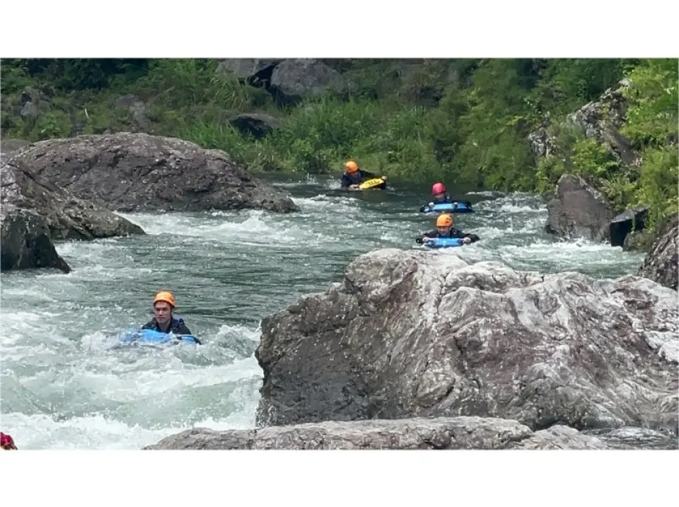 I swim down the river with a boat that looks like a kickboard.