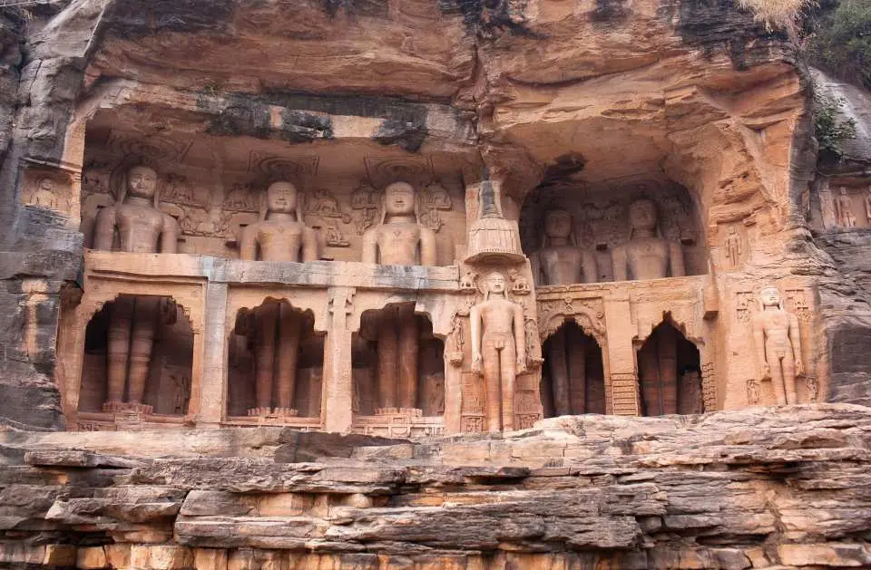 Gwalior Fort is a majestic hill fortress known as the "Gibraltar of India," renowned for its impenetrable sandstone walls and the stunning blue-tiled Man Mandir Palace. Spanning nearly three kilometers, it houses a rich collection of historic monuments, including the unique Teli Ka Mandir and ancient rock-cut Jain sculptures carved into the cliffs.