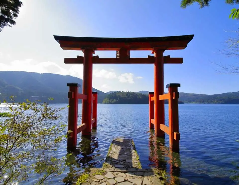 Water-based Torii Gates | A Crimson Retreat Standing on the Lake's Surface Proudly standing above the lake, their elegant and imposing crimson form makes them a classic landmark of Hakone Shrine, also known as the Peace Torii Gate.