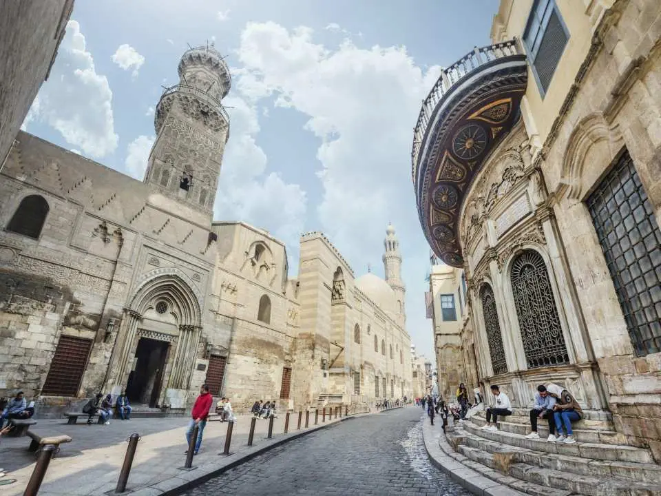 Your tour begins with pickup from your hotel or selected pickup point. Transfer time may vary depending on your hotel location, and final pickup details are confirmed one day before the activity. After meeting your guide and driver, travel by air-conditioned vehicle to begin the route.

Start at Amr Ibn Al-As Mosque, where your guide introduces the Islamic heritage section according to the selected language and package. Continue to the Hanging Church, Abu Serga Church, and Ben Ezra Synagogue for the Coptic Cairo section.

Afterward, continue to El-Moez for a guided historic street experience, then visit Khan El Khalili Bazaar. The final activity is the Felucca Ride Cairo on the Nile, subject to weather, wind, Nile conditions, and local operation.

Lunch is included only if the with tickets and lunch package is selected. If the without tickets and lunch package is selected, lunch is not included. If your selected package includes tickets, the listed required entry is included. If not, entry fees are paid separately if required. At the end of the tour, return by vehicle for drop-off.