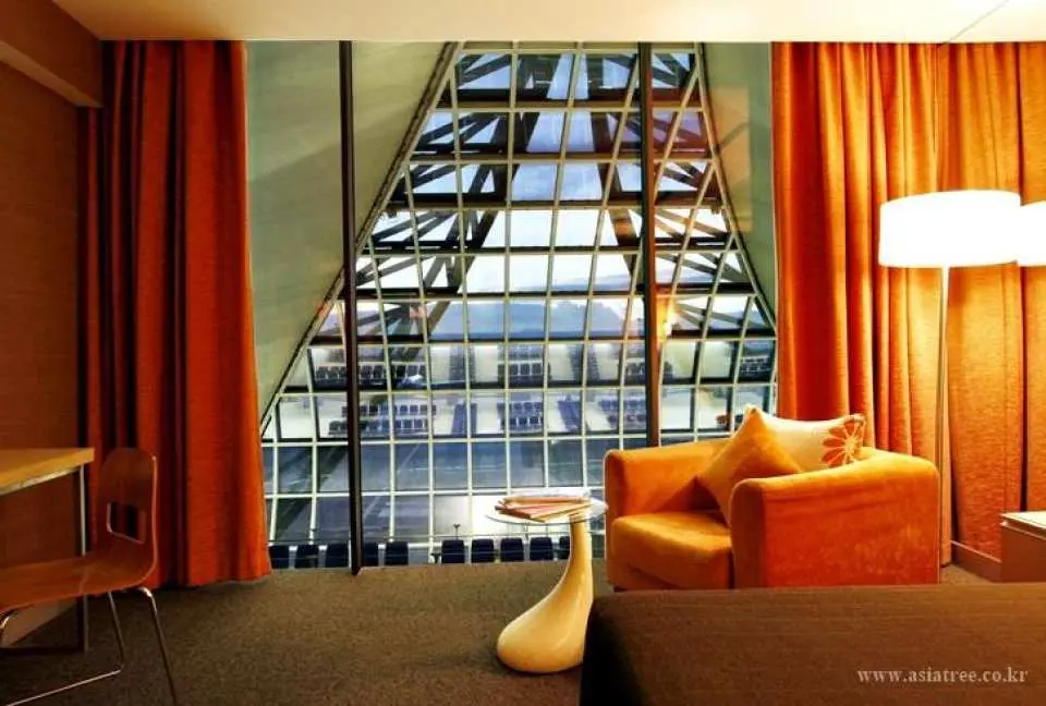 A small table located in the room. It has an airport view.