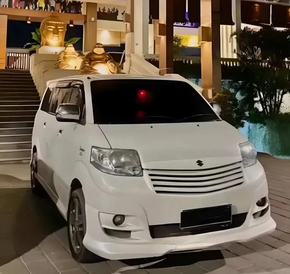 A spacious white private transfer vehicle, ready to transport travelers to Mount Batur in Bali, starting a comfortable and convenient jeep and hiking tour.