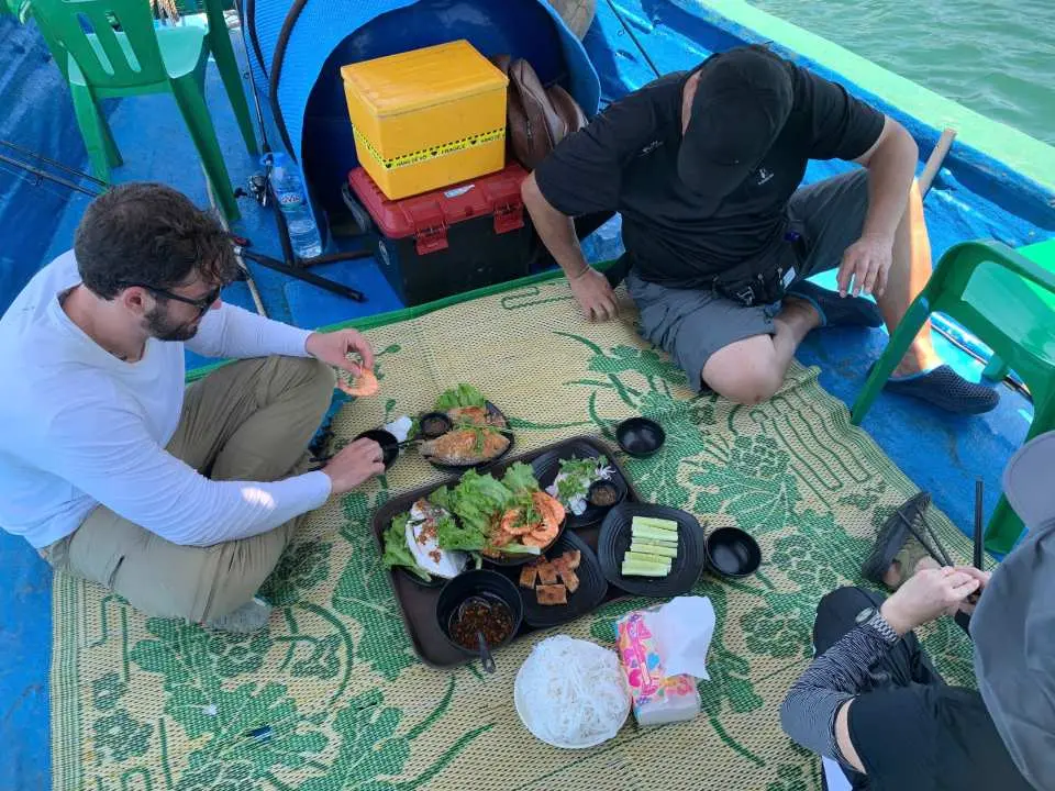 旅客們在越南峴港山茶半島的漁船上享用新鮮海鮮午餐，包括刺身，體驗用當天漁獲烹製的美食。