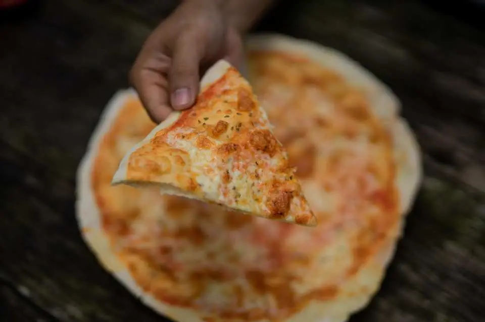 Savor authentic wood-fired Italian brick oven pizza served fresh at a hidden beachfront spot, where delicious flavors blend perfectly with the relaxing ocean breeze.
