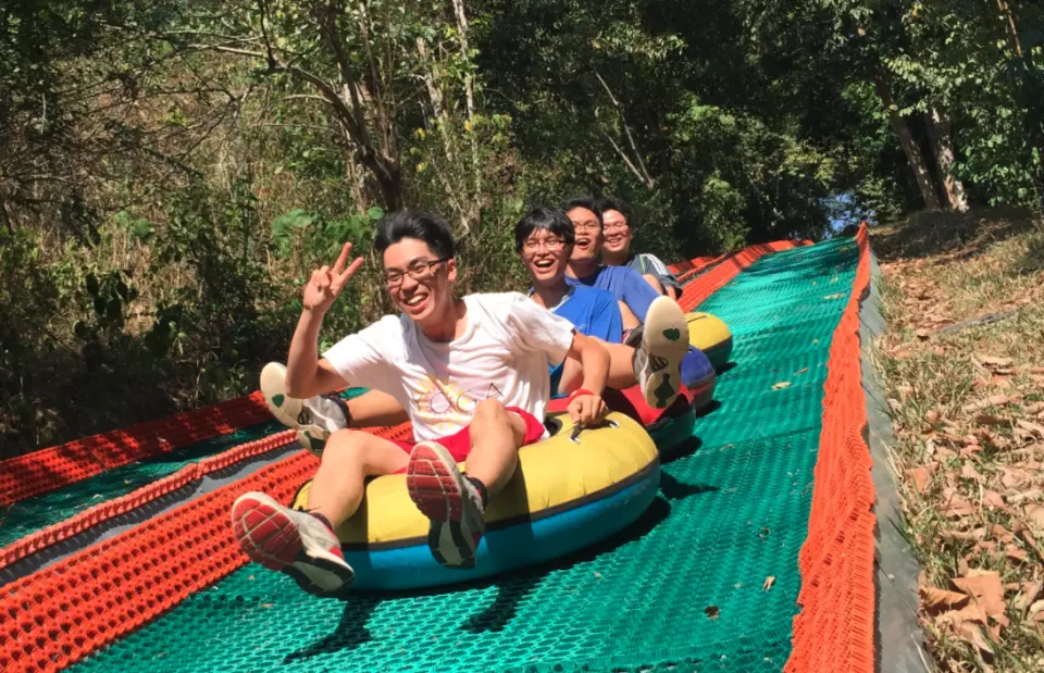 guests riding down a rubber mat track