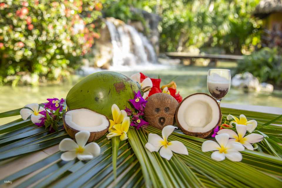 Delight in a tropical tea break amidst an enchanting artificial waterfall