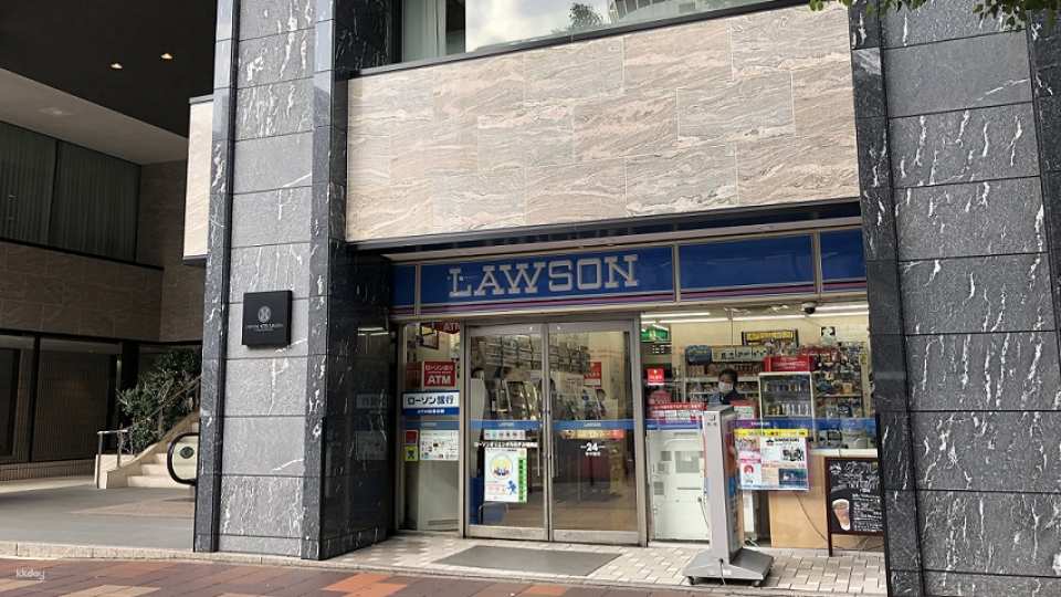 Wait in front of the Lawson convenience store at Oriental Hotel