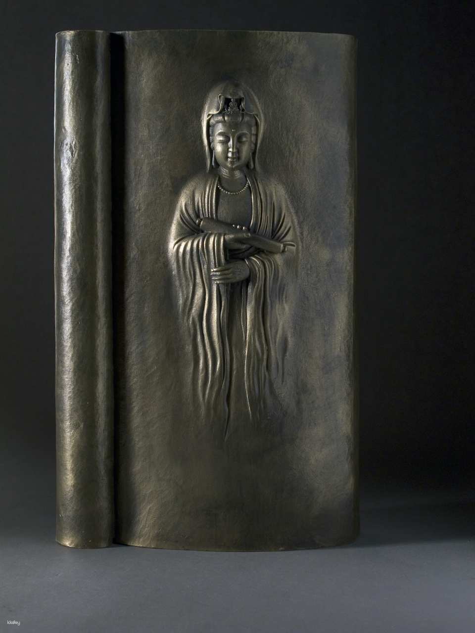 Bronze sculpture: Guanyin in the book